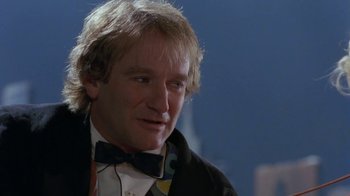 Movie still from “Toys” (1992), directed by Barry Levinson – A person wearing a bow tie; Close Up shot, Over the shoulder angle
