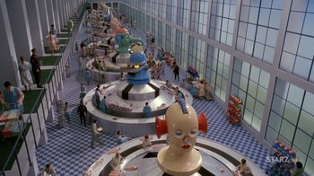 Movie still from “Toys” (1992), directed by Barry Levinson – A group of people standing in a room with a lot of sculptures; Extreme Wide shot, High angle