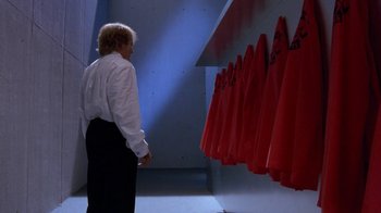Movie still from “Toys” (1992), directed by Barry Levinson – A man standing in front of a row of red towels; Wide shot, Low angle