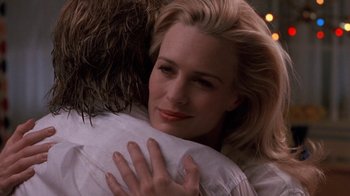 Movie still from “Toys” (1992), directed by Barry Levinson – A person hugging another person; Close Up shot, Over the shoulder angle