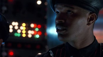 Movie still from “Toys” (1992), directed by Barry Levinson – A person wearing a hat; Close Up shot, Over the shoulder angle