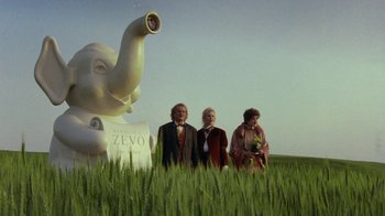 Movie still from “Toys” (1992), directed by Barry Levinson – A group of people standing next to an elephant statue; Wide shot, Low angle