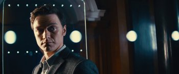 Movie still from “Trance” (2013), directed by Danny Boyle – A person wearing a suit and tie; Close Up shot, Low angle