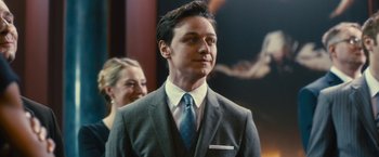 Movie still from “Trance” (2013), directed by Danny Boyle – A man wearing a suit and tie standing next to a woman; Close Up shot, Over the shoulder angle