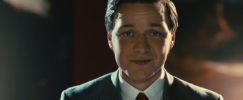 Movie still from “Trance” (2013), directed by Danny Boyle – A person wearing a suit and tie; Close Up shot, Over the shoulder angle