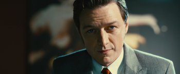 Movie still from “Trance” (2013), directed by Danny Boyle – A person wearing a suit and tie; Close Up shot, Low angle