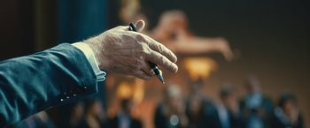 Movie still from “Trance” (2013), directed by Danny Boyle – A person holding a pen in their hand; Extreme Close Up shot, High angle
