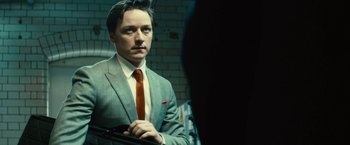 Movie still from “Trance” (2013), directed by Danny Boyle – A man wearing a suit and tie in front of a mirror; Close Up shot, Low angle