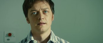 Movie still from “Trance” (2013), directed by Danny Boyle – A person wearing a blue shirt; Close Up shot, Low angle