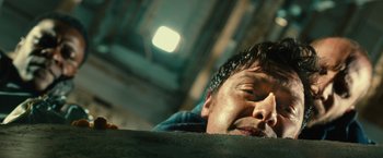 Movie still from “Trance” (2013), directed by Danny Boyle – A person wearing a blue shirt; Close Up shot, Overhead angle