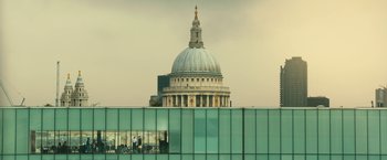 Movie still from “Trance” (2013), directed by Danny Boyle – The dome of a building is reflected in a window; Extreme Wide shot, Low angle
