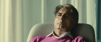 Movie still from “Trance” (2013), directed by Danny Boyle – A person sitting in a chair; Close Up shot, Low angle