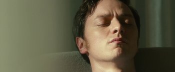 Movie still from “Trance” (2013), directed by Danny Boyle – A person with his eyes closed; Close Up shot, Low angle