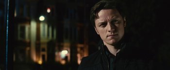 Movie still from “Trance” (2013), directed by Danny Boyle – A person wearing a black jacket; Close Up shot, Low angle