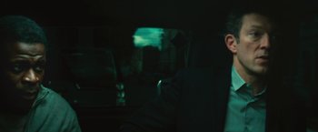 A person sitting in a car in the dark