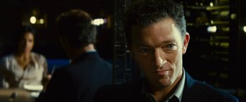 Movie still from “Trance” (2013), directed by Danny Boyle – A person wearing a suit and tie; Close Up shot, Over the shoulder angle