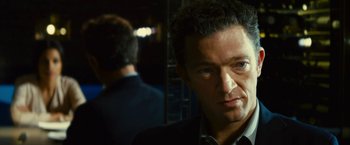 Movie still from “Trance” (2013), directed by Danny Boyle – A person wearing a suit and tie; Close Up shot, Over the shoulder angle