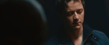 Movie still from “Trance” (2013), directed by Danny Boyle – A person in a dark room; Close Up shot, Over the shoulder angle