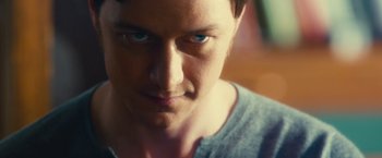 Movie still from “Trance” (2013), directed by Danny Boyle – A man's face with blue eyes; Close Up shot, Over the shoulder angle