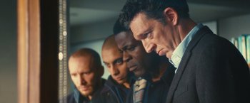 Movie still from “Trance” (2013), directed by Danny Boyle – A group of men standing next to each other; Close Up shot, Low angle