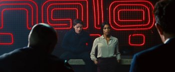 Movie still from “Trance” (2013), directed by Danny Boyle – A man and a woman sitting in front of a neon sign; Medium shot, Over the shoulder angle