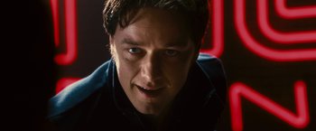 Movie still from “Trance” (2013), directed by Danny Boyle – A man's face in a dark room; Close Up shot, Low angle