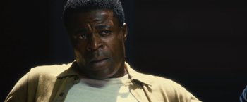 Movie still from “Trance” (2013), directed by Danny Boyle – A person wearing a white shirt; Close Up shot, Low angle