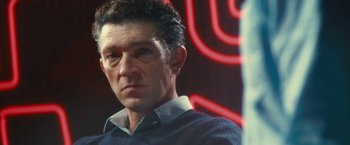 Movie still from “Trance” (2013), directed by Danny Boyle – A person wearing a blue shirt; Close Up shot, Low angle