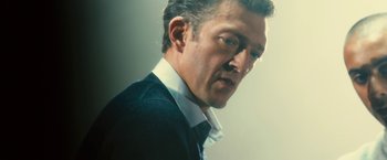 Movie still from “Trance” (2013), directed by Danny Boyle – A person wearing a shirt and jacket; Close Up shot, Low angle