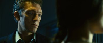 Movie still from “Trance” (2013), directed by Danny Boyle – A person wearing a suit and tie; Close Up shot, Low angle