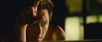 Movie still from “Trance” (2013), directed by Danny Boyle – A man's face with his hand touching his forehead; Close Up shot, Low angle