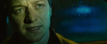 Movie still from “Trance” (2013), directed by Danny Boyle – A man's face in the dark; Close Up shot, Low angle