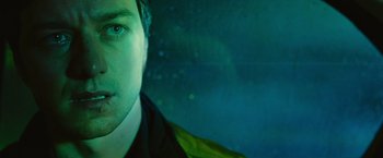 Movie still from “Trance” (2013), directed by Danny Boyle – A man's face in the dark; Close Up shot, Low angle