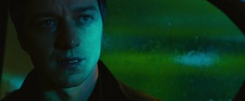 Movie still from “Trance” (2013), directed by Danny Boyle – A person wearing a black shirt; Close Up shot, Low angle