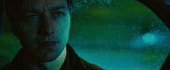 Movie still from “Trance” (2013), directed by Danny Boyle – A man's face in the dark; Close Up shot, Over the shoulder angle