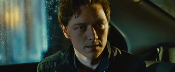 Movie still from “Trance” (2013), directed by Danny Boyle – A man's face in the dark; Close Up shot, Low angle