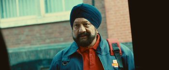 Movie still from “Trance” (2013), directed by Danny Boyle – A man with a beard wearing a blue turban; Close Up shot, Low angle