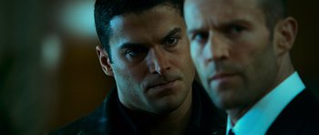 Movie still from “Transporter 3” (2008), directed by Olivier Megaton – A man's face as he stares at the camera; Close Up shot, Over the shoulder angle