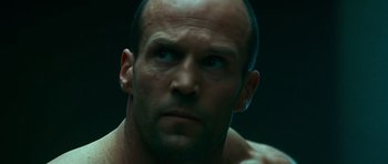 Movie still from “Transporter 3” (2008), directed by Olivier Megaton – A man's face in a dark room; Close Up shot, Low angle