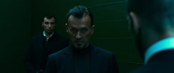 Movie still from “Transporter 3” (2008), directed by Olivier Megaton – A person wearing a suit and tie; Close Up shot, Low angle