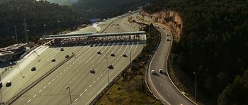 Movie still from “Transporter 3” (2008), directed by Olivier Megaton – An aerial view of a highway with cars driving on it; Extreme Wide shot, High angle