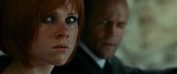 Movie still from “Transporter 3” (2008), directed by Olivier Megaton – A person wearing a suit and tie; Close Up shot, Over the shoulder angle