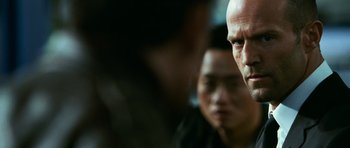 Movie still from “Transporter 3” (2008), directed by Olivier Megaton – A man with a bald head; Close Up shot, Over the shoulder angle