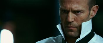 Movie still from “Transporter 3” (2008), directed by Olivier Megaton – A man that is staring at the camera; Close Up shot, Low angle