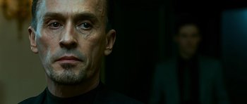 Movie still from “Transporter 3” (2008), directed by Olivier Megaton – A person with a black shirt; Close Up shot, Low angle