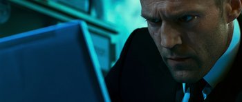 Movie still from “Transporter 3” (2008), directed by Olivier Megaton – A person using a laptop computer; Close Up shot, Low angle