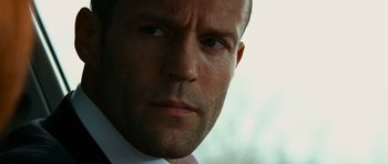 Movie still from “Transporter 3” (2008), directed by Olivier Megaton – A person wearing a suit and tie; Close Up shot, Low angle