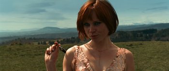 Movie still from “Transporter 3” (2008), directed by Olivier Megaton – A woman with red hair holding a cell phone in her hand; Close Up shot, Low angle