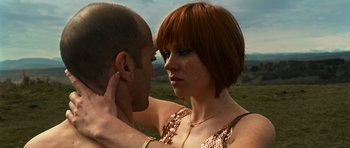 Movie still from “Transporter 3” (2008), directed by Olivier Megaton – A man and a woman face to face in a field; Close Up shot, Low angle