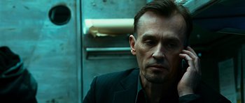 Movie still from “Transporter 3” (2008), directed by Olivier Megaton – A person wearing a suit and tie; Close Up shot, Low angle